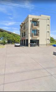 a building with a car parked in a parking lot at Shiyue Homestay in Zhuangwei +9 photos