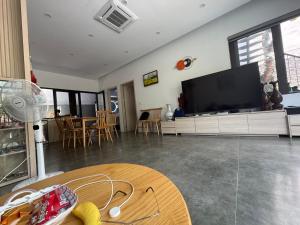 a living room with a large flat screen tv at Đông Hương Home in Cat Ba