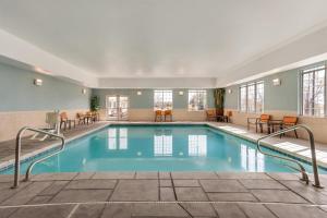 a pool in a hotel with tables and chairs at Hyatt Place Santa Fe in Santa Fe