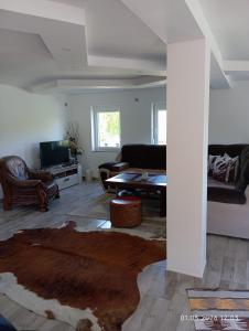 a living room with a couch and a table at WallerKarpfenBosnien in Šiljkovača
