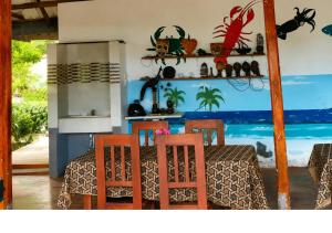 a dining room with a table and four chairs at DA GREA NATURAL BEACH HOTEL in Trincomalee