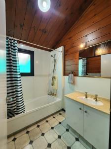 a bathroom with a tub and a sink and a shower at Ruapehu Farm Chalet in Ohakune +11 photos