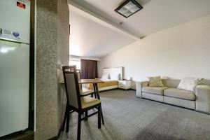 a living room with a couch and a table in a room at Grecheskaya Central Suites in Odesa