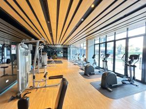 a gym with a lot of treadmills and ellipticals at Sanphawut IDEO CONDO in Bang Chak