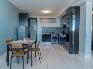 a kitchen with a dining room table and chairs at 77 ON Independence Avenue in Windhoek