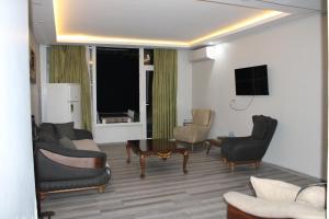 a living room with couches and chairs and a tv at Deniz Hotel Kumburgaz in Büyükçekmece +17 photos