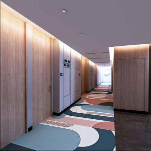 a hallway of an office with colorful carpet at Swiss-Belexpress K Square Batam in Batam Center