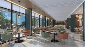 a restaurant with tables and chairs and windows at Swiss-Belexpress K Square Batam in Batam Center