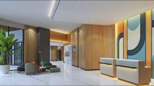 a lobby with a couch and a chair and a table at Swiss-Belexpress K Square Batam in Batam Center