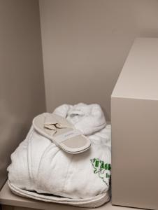 a pile of towels and a pair of sandals on a table at Hotel Il Tiglio in Castel di Sangro +76 photos