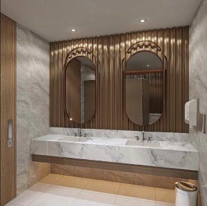 a bathroom with two sinks and two mirrors at Swiss-Belexpress K Square Batam in Batam Center