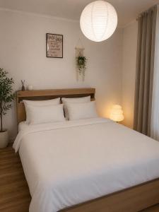 a bedroom with a large bed with white sheets at Herry Stay in Seoul