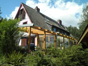 a house with a gambrel roof with glass windows at Frauenpension Arleta - Women only in Goslar