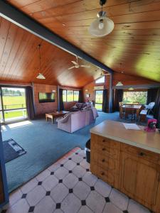 a large living room with a couch and a table at Ruapehu Farm Chalet in Ohakune