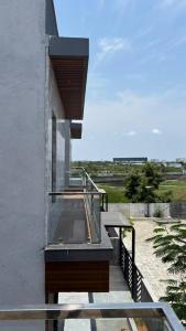 a house with a glass staircase on the side of it at Md Couple Stay in Covelong
