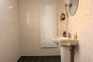 a white bathroom with a sink and a mirror at Herry Stay in Seoul