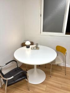 a white table and chairs in a room at Herry Stay in Seoul +30 photos