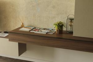 a wooden counter with books and a plant on it at ALandGIO Smart Stay in Cavallino-Treporti