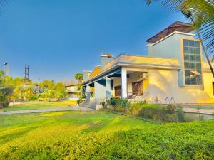 a house with a palm tree in front of it at New Central villa in Bapsai