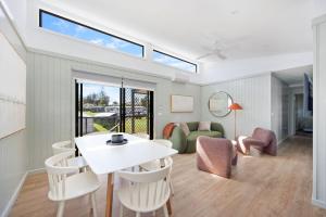 a living room with a white table and chairs at Reflections Bermagui - Holiday Park in Bermagui