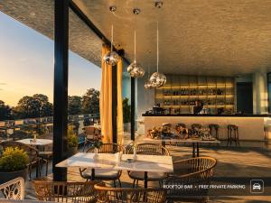 a restaurant with tables and chairs and a bar at Kobuleti Garden Inn in Kobuleti