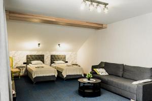a living room with two beds and a couch at Naktsmītne - Fišers in Viesīte