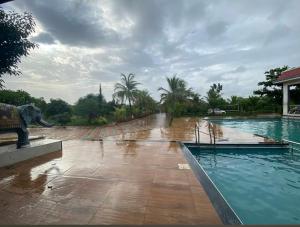 a pool with an elephant statue in the middle at New Central villa in Bapsai