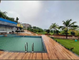 a swimming pool with tongs in the middle at New Central villa in Bapsai