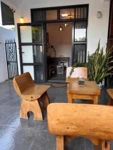 a living room with wooden chairs and a table at Serenity Apartments in Albion