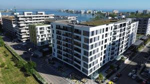 an aerial view of a white apartment building at AVI GARDEN Apartments in Constanţa