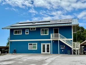 a blue building with a solar roof on it at Silver Dollar Tree in Kealakekua