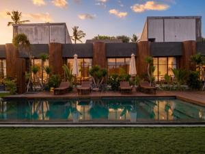 an exterior view of a house with a swimming pool at Frontera Nyanyi in Tabanan