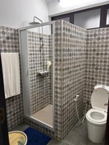 a bathroom with a shower with a toilet at Serenity Apartments in Albion +41 photos