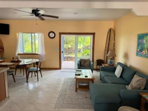 a living room with a couch and a table at Silver Dollar Tree in Kealakekua