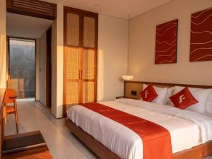 a bedroom with a large bed and a window at Frontera Nyanyi in Tabanan +18 photos