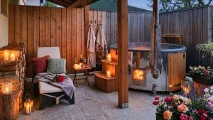 a patio with a hot tub and a chair and candles at Glamping Kranjc in Kobarid