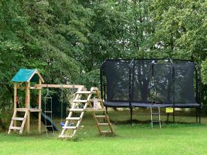 a playground with a play set and a trampoline at Ferienwohnanlage Königerode in Königerode