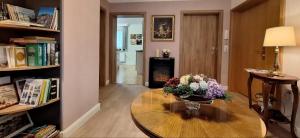 a room with a table with a vase of flowers on it at Ferienwohnung Zum Gartenparadies in Oppach
