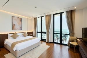 a hotel room with a bed and a balcony at Osea Hotel in Sihanoukville +65 photos