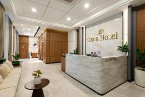 a lobby of a casa hotel with a reception desk at Osea Hotel in Sihanoukville
