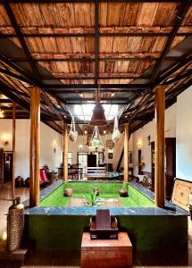 a living room with a green lawn in the middle at Cherys Bunglow Homestay- Rooms in Thiruvalla