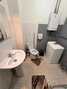 a bathroom with a toilet and a sink at Gengoult 1 in Toul