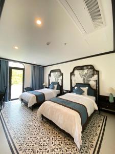 a bedroom with two beds and a large window at Le Dung Hotel in Tam Kỳ +37 photos