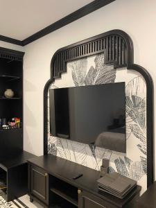 a bedroom with a large mirror on the wall at Le Dung Hotel in Tam Kỳ