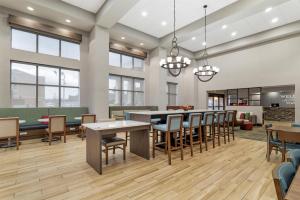 an office lobby with tables and chairs and a cafeteria at Hampton Inn & Suites Augusta West in Quail Creek