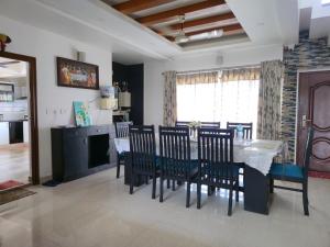 a kitchen and dining room with a table and chairs at Captains Cabin, Alleppey- A Premium Backwater Mansion in Alleppey