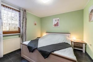 a bedroom with a bed and a desk and a window at Ferienhaus Mayer in Idar-Oberstein