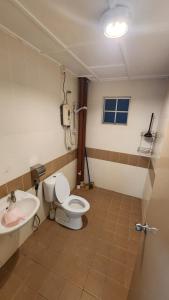 a bathroom with a toilet and a sink at Merlin Home@Crown Imperial Court in Tanah Rata