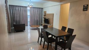 a dining room and living room with a table and chairs at Merlin Home@Crown Imperial Court in Tanah Rata +45 photos