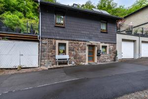 a large house with a garage and a driveway at Ferienhaus Mayer in Idar-Oberstein